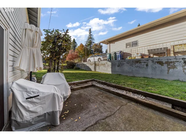 a view of a porch with furniture and garden