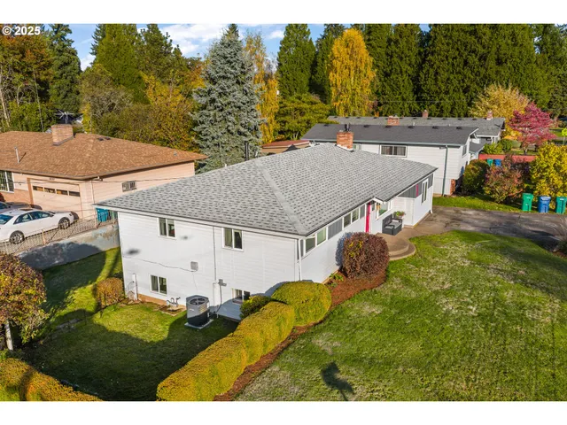a view of a house with a yard and potted plants