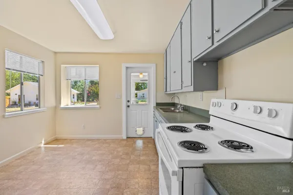 a kitchen with a stove and a refrigerator