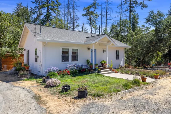 a front view of a house with a yard and outdoor seating