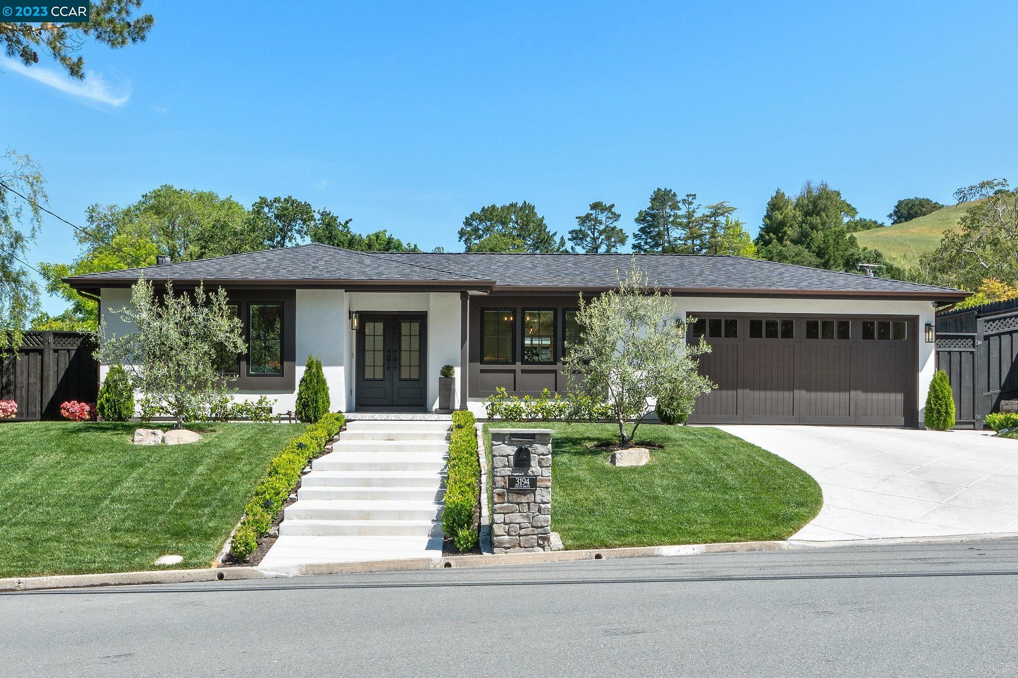 a front view of a house with a yard table and chairs
