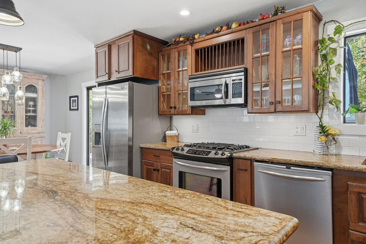 10376 Tabeaud Road Pine Grove, CA 95665 - Photo 22 of 70 a kitchen with stainless steel appliances granite countertop a refrigerator stove top oven a sink and dishwasher