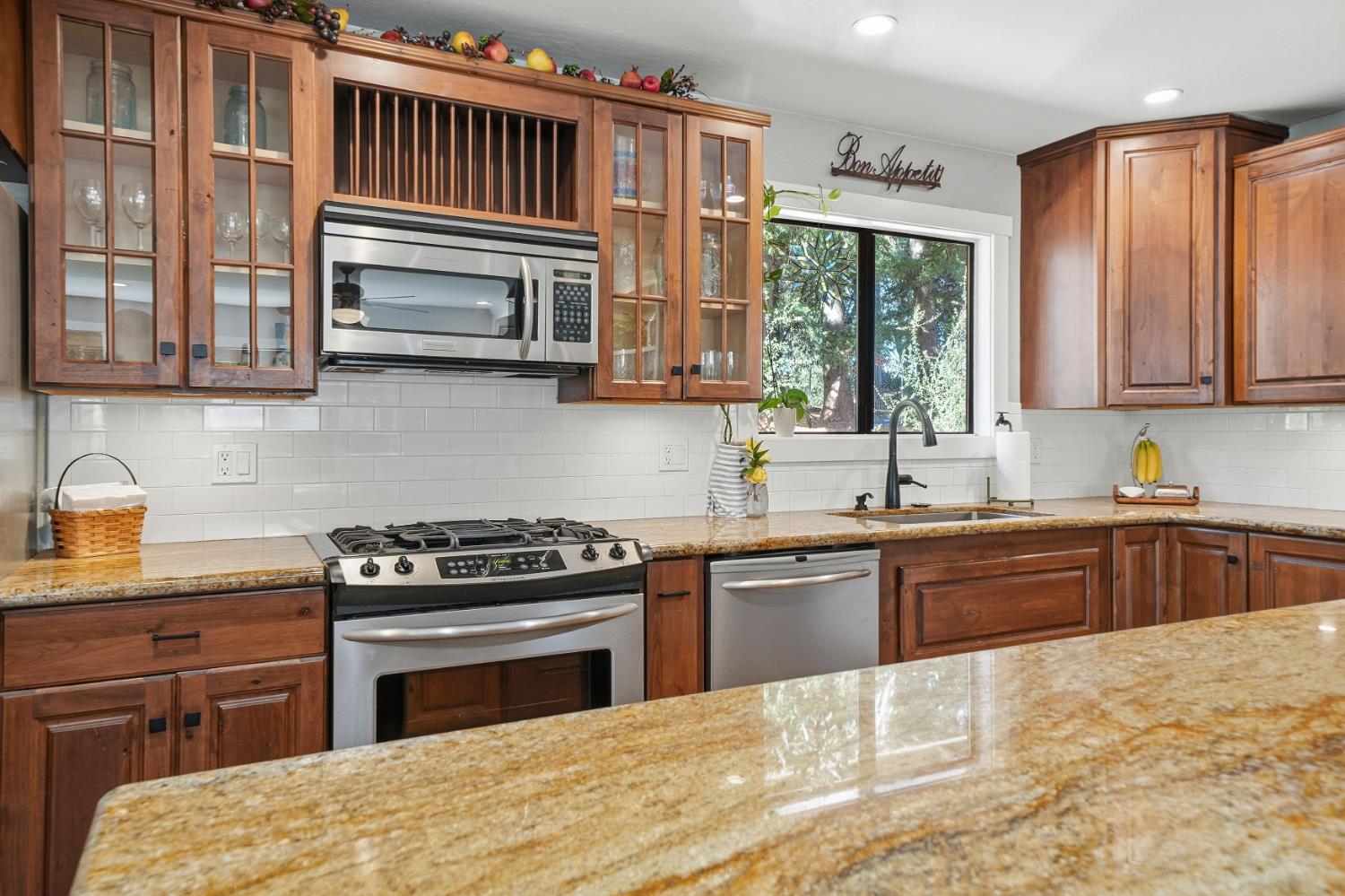 10376 Tabeaud Road Pine Grove, CA 95665 - Photo 26 of 70 a kitchen with stainless steel appliances granite countertop a stove a sink and a microwave