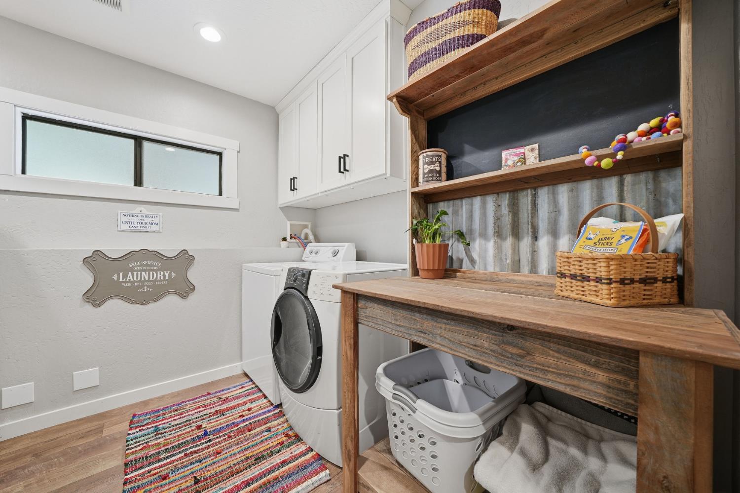 10376 Tabeaud Road Pine Grove, CA 95665 - Photo 32 of 70 Laundry room, with custom cabinets above washer & dryer, room for refrigerator to the left also home of the tankless water heater