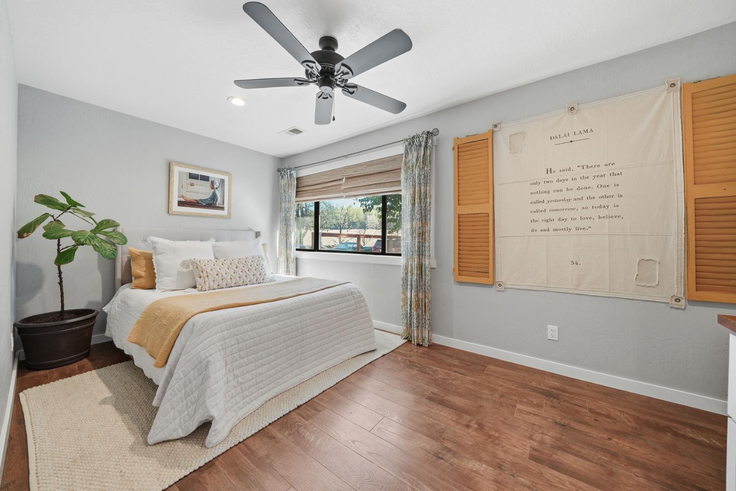 10376 Tabeaud Road Pine Grove, CA 95665 - Photo 33 of 70 a spacious bedroom with a large bed chandelier and a window