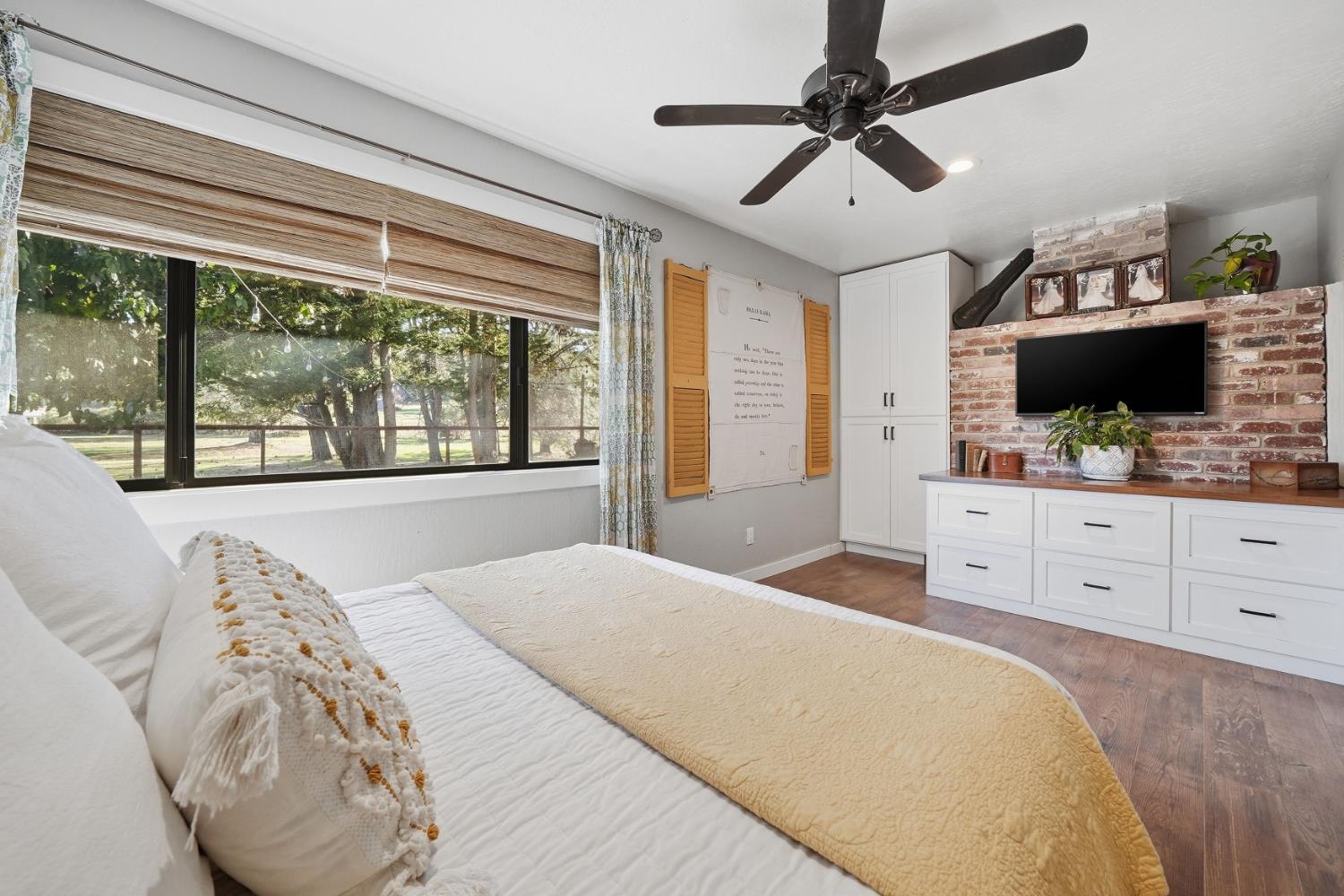 10376 Tabeaud Road Pine Grove, CA 95665 - Photo 34 of 70 a bedroom with a large bed and a flat tv screen on dresser