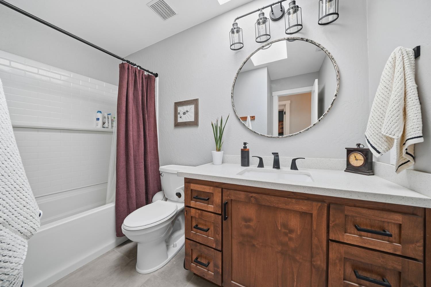 10376 Tabeaud Road Pine Grove, CA 95665 - Photo 44 of 70 a bathroom with a toilet sink vanity tub and mirror