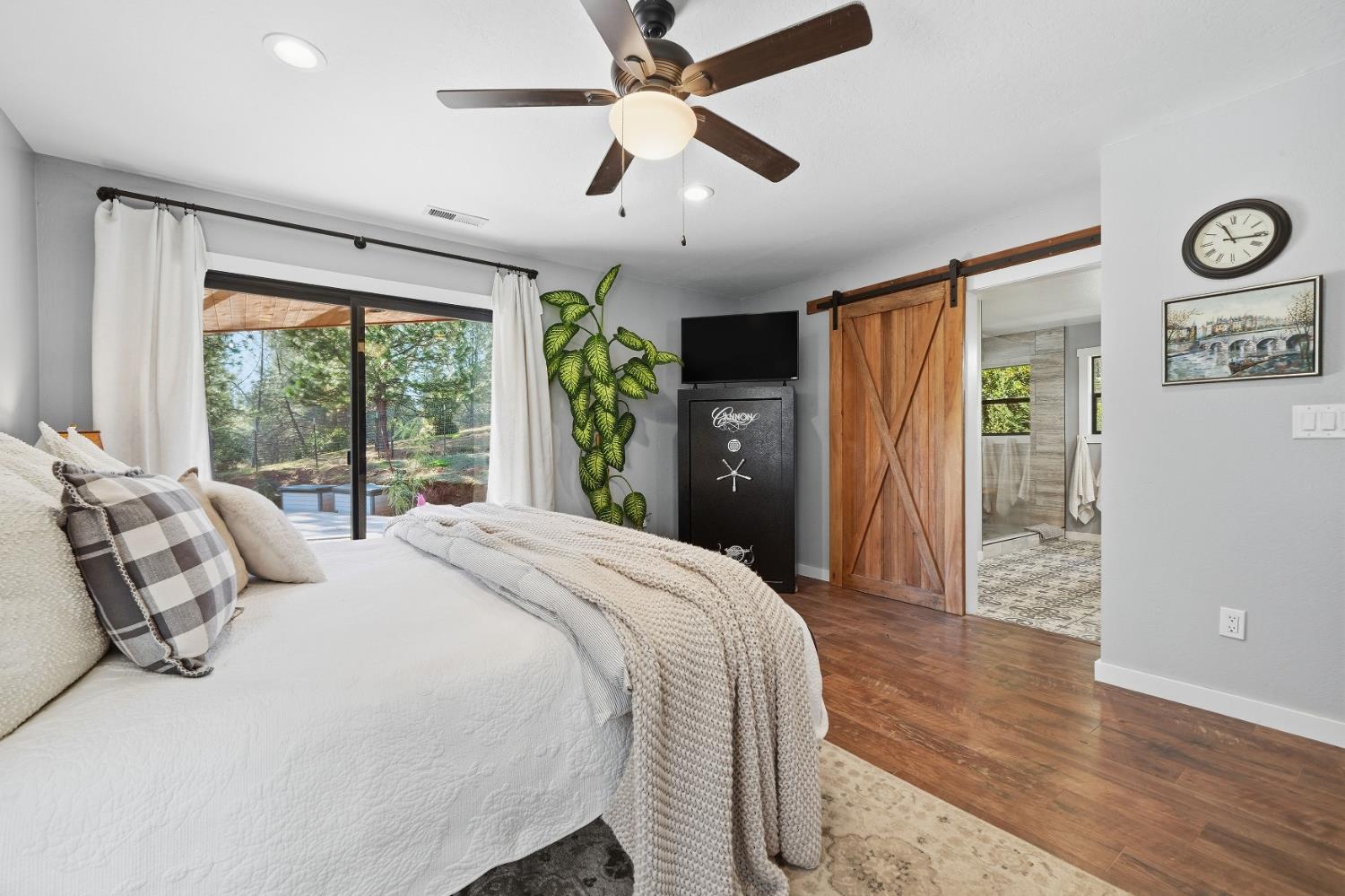 10376 Tabeaud Road Pine Grove, CA 95665 - Photo 47 of 70 a bedroom with a large bed and a large window