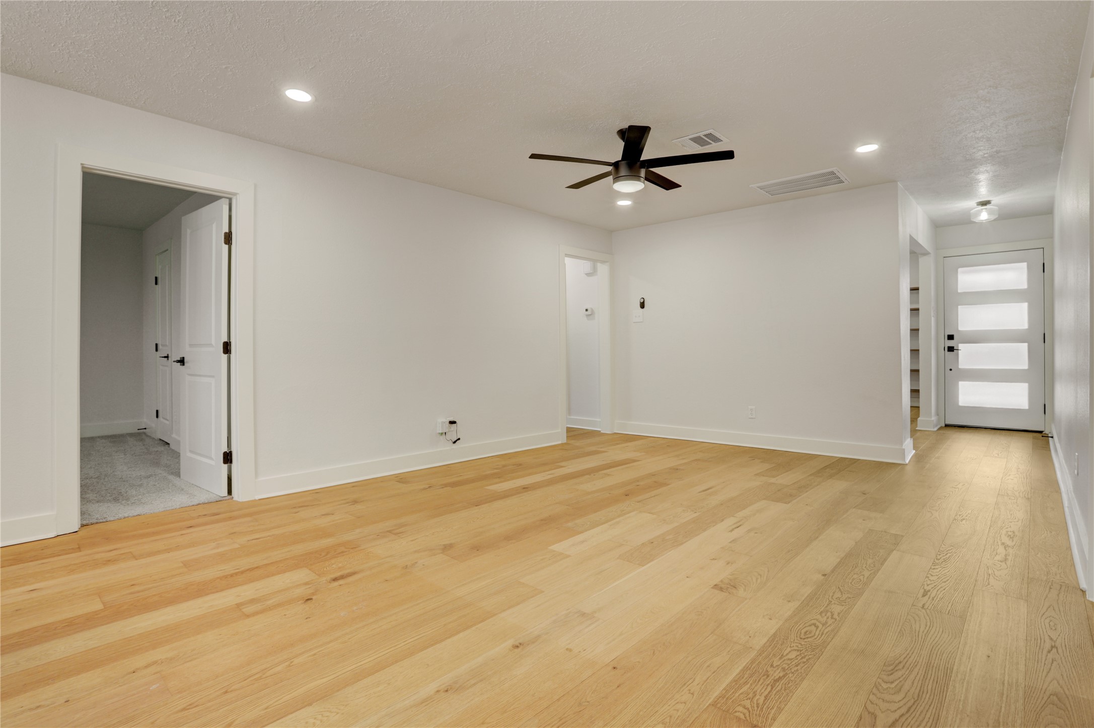 5514 Indigo Street Houston, TX 77096 - Photo 8 of 22 a view of a big room with wooden floor and windows