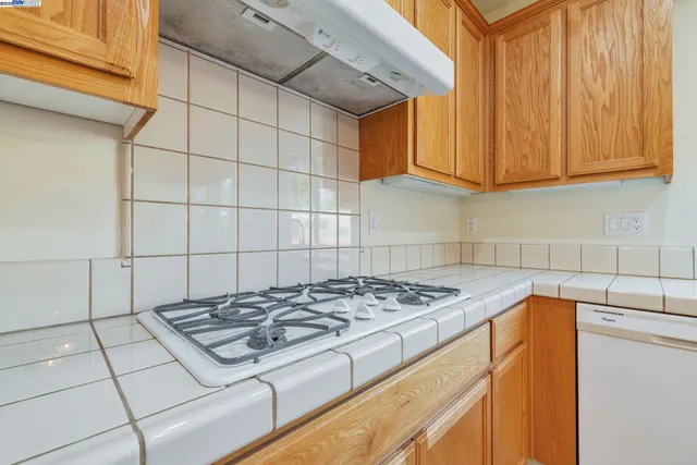 a stove top oven sitting inside of a kitchen