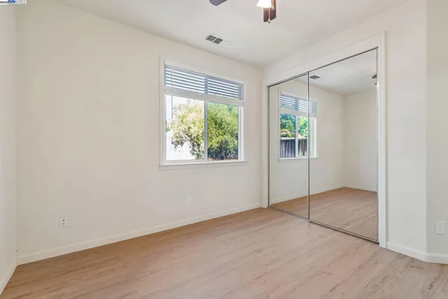 an empty room with windows and closet