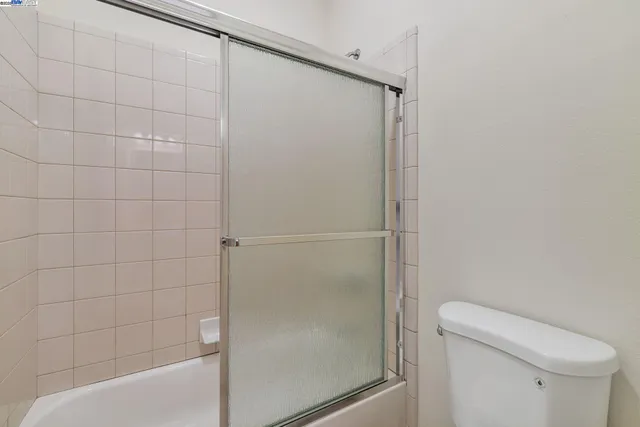 a bathroom with a shower and a toilet