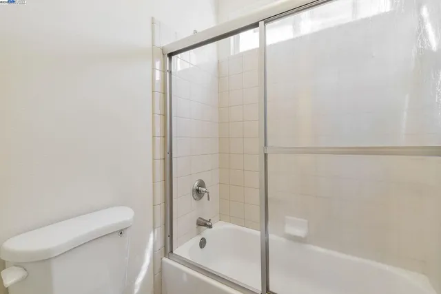 a bathroom with a bathtub and a toilet