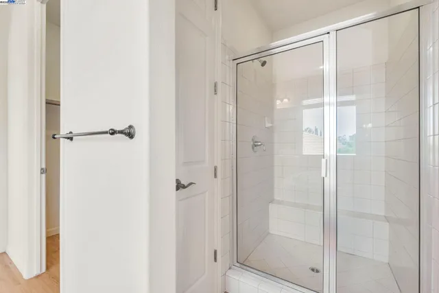 a bathroom with a glass shower door
