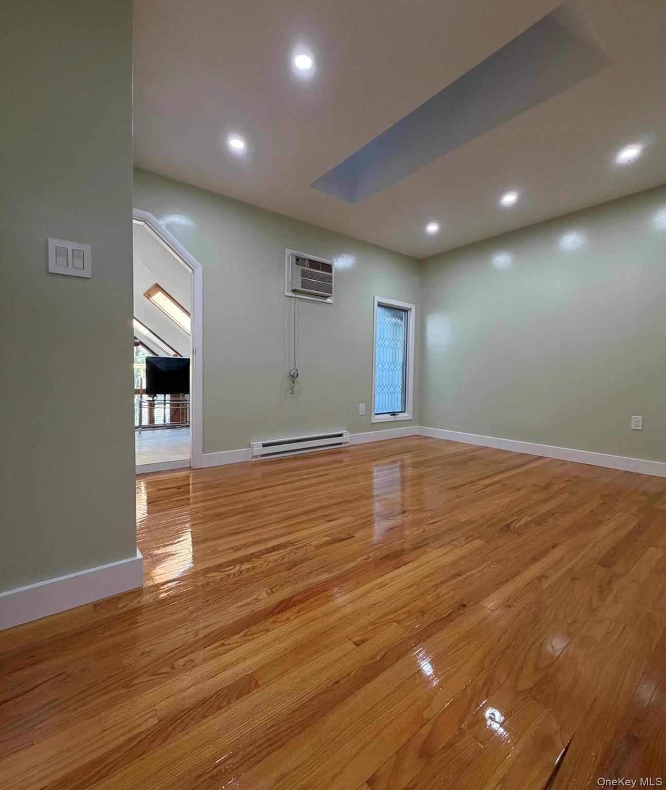 60 Medallion Road Kiamesha Lake, NY 12751 - Photo 37 of 44 a view of empty room with wooden floor and kitchen view