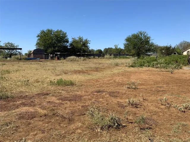 a view of a field with an ocean