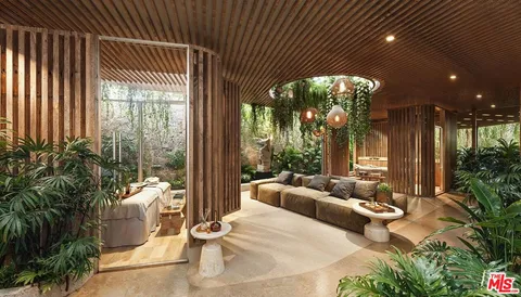 a living room with furniture and a potted plant