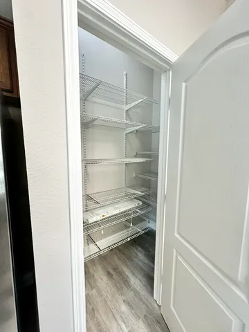 a view of a room with wooden floor