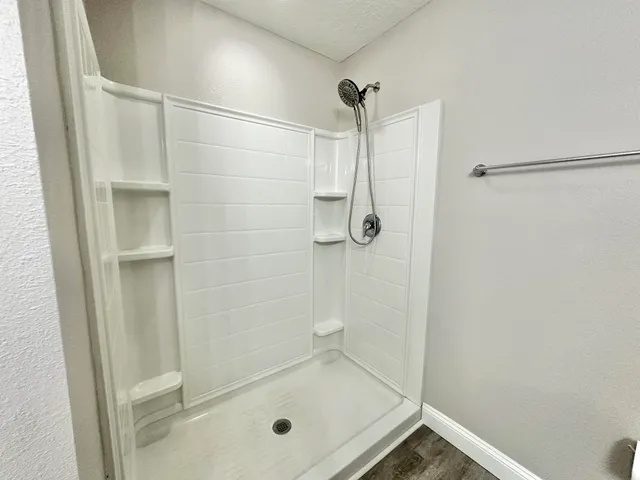 a bathroom with a sink toilet vanity and shower