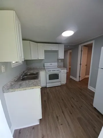 a kitchen with wooden floors and a stove