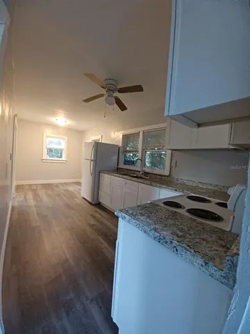 a kitchen with a stove and a refrigerator
