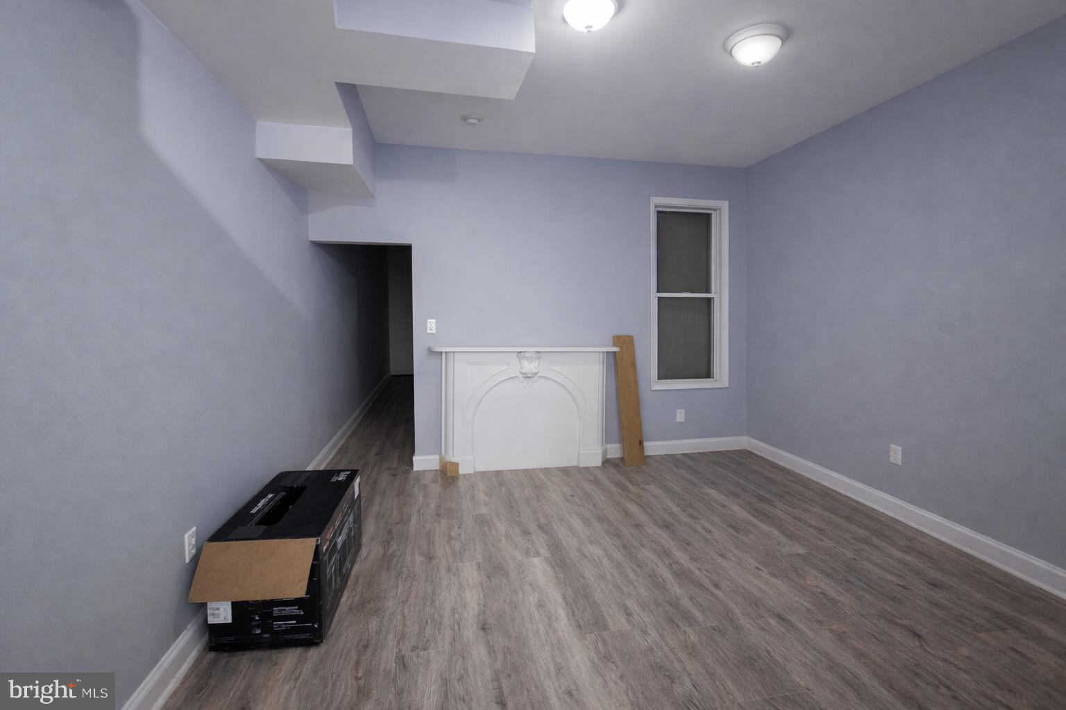 1916 West Lanvale Street Baltimore, MD 21217 - Photo 5 of 15 an empty room with wooden floor and white wall