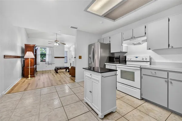 a kitchen with white cabinets and white appliances