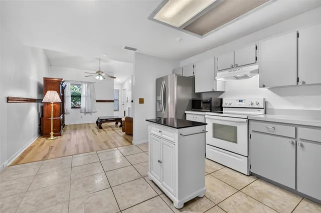a kitchen with white cabinets and white appliances