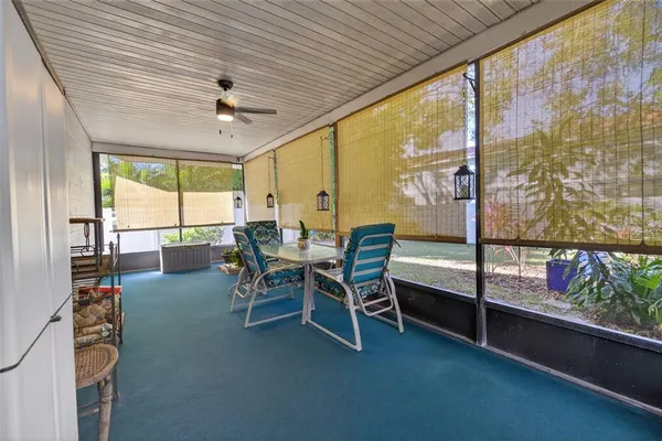 a dining room with furniture and a floor to ceiling window