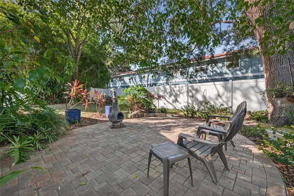 a view of a chairs and table in backyard