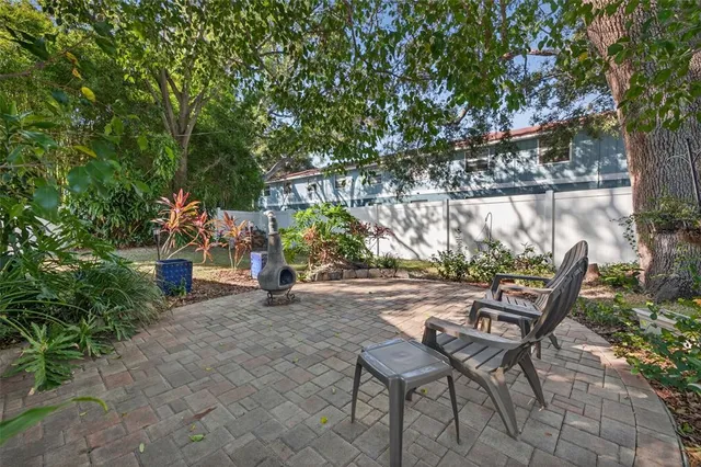 a view of a chairs and table in backyard