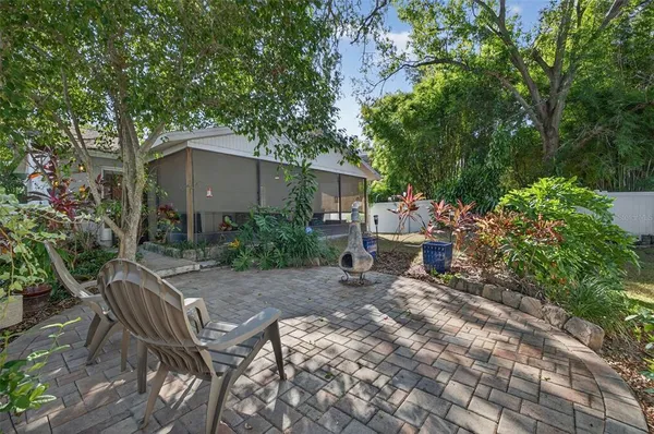 a view of backyard with outdoor seating and trees