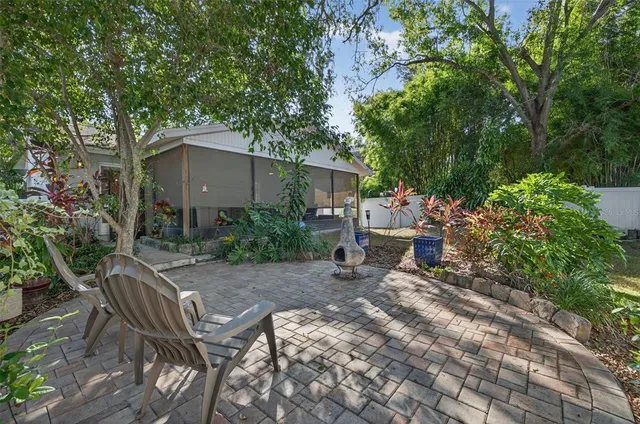 a view of backyard with outdoor seating and trees