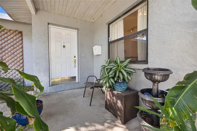 a view of balcony with two chairs and a potted plant