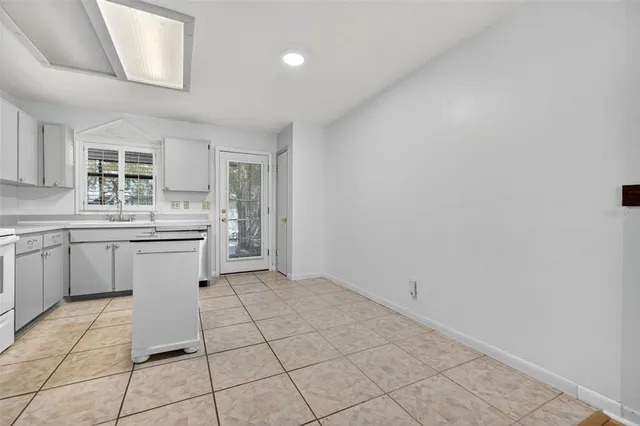 a kitchen with a sink cabinets and window