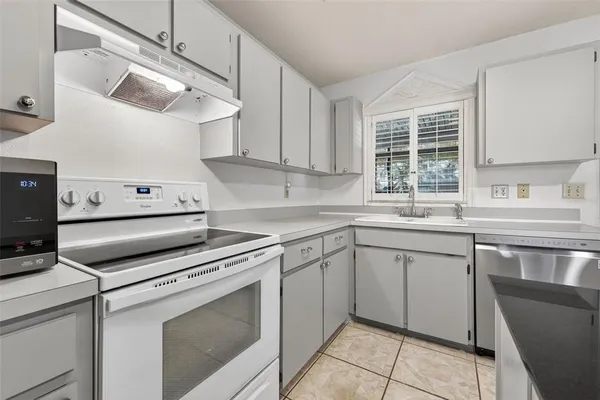 a kitchen with a stove cabinets and a sink
