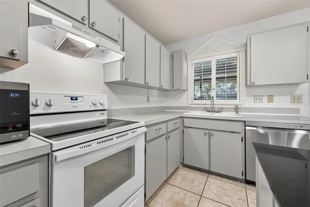 a kitchen with a stove cabinets and a sink
