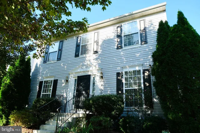 a view of house with yard and green space