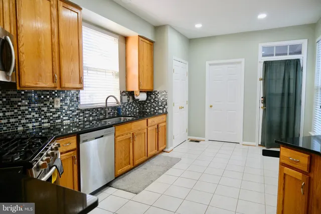 a view of a kitchen with granite countertop cabinets