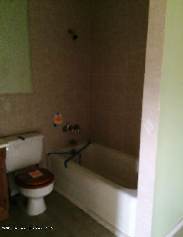 355 Middle Road Hazlet, NJ 07730 - Photo 8 of 13 a white toilet sitting next to a shower