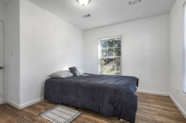 a bedroom with a bed and a window