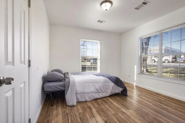 a bedroom with a bed and window