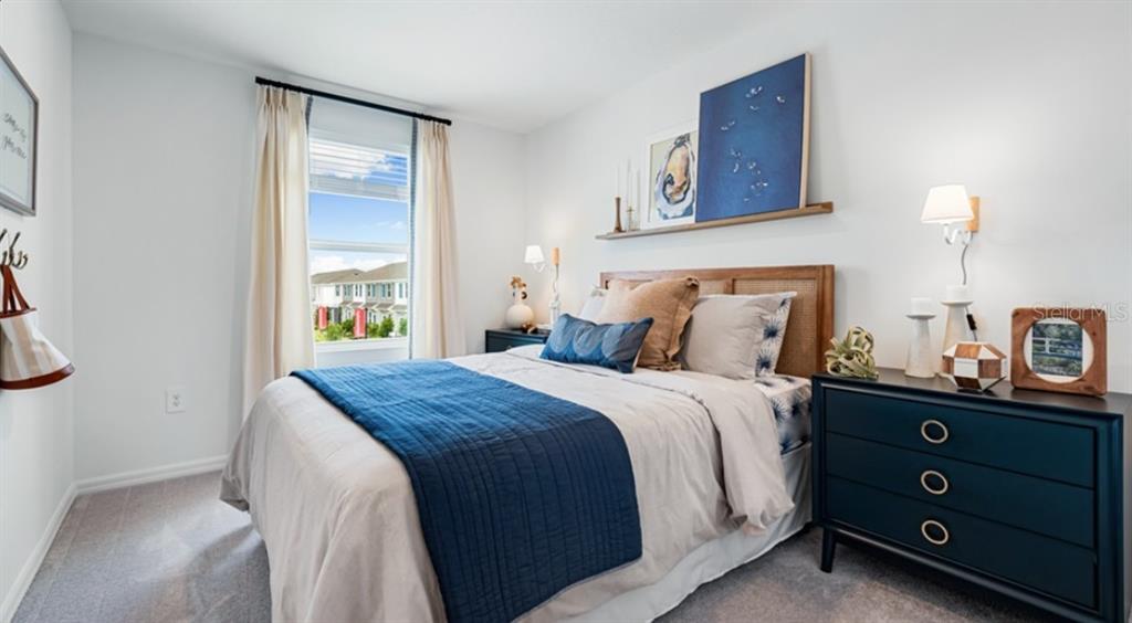 13154 Stable Place Parrish, FL 34219 - Photo 13 of 18 a bedroom with a bed and a night stand