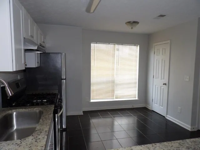 a view of a kitchen with a sink dishwasher and fireplace