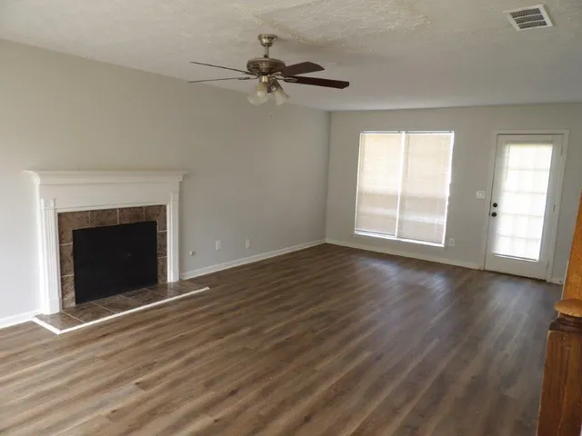 wooden floor fireplace and natural light in room