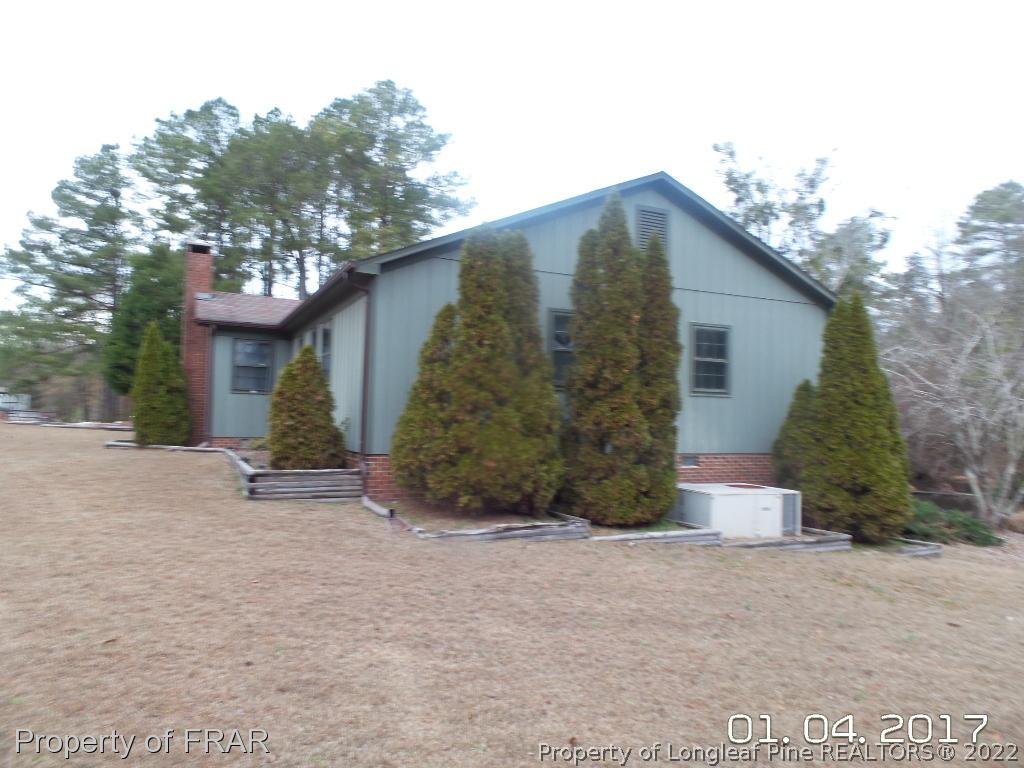 5141 Rockingham Road Laurel Hill, NC 28351 - Photo 2 of 14 a front view of a house with a yard and garage