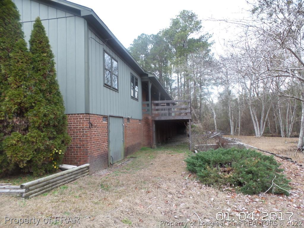 5141 Rockingham Road Laurel Hill, NC 28351 - Photo 3 of 14 a view of a house with a yard