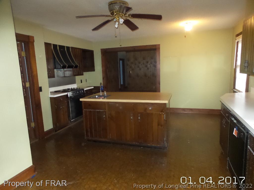 5141 Rockingham Road Laurel Hill, NC 28351 - Photo 7 of 14 a kitchen with stainless steel appliances granite countertop a stove a sink and a refrigerator