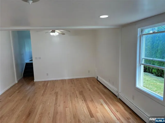 a view of room with window and wooden floor