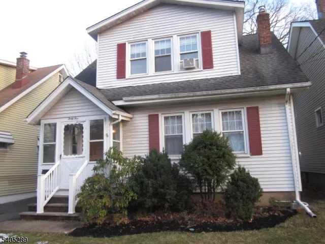 a view of a house with a yard and plants